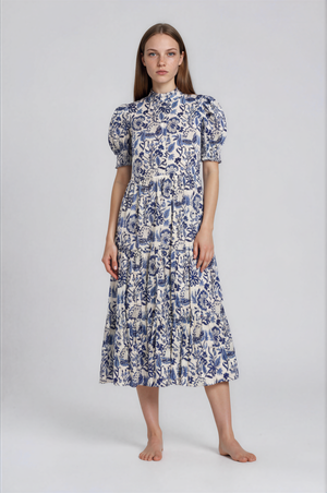 Woman wearing a blue and white floral dress on a white background