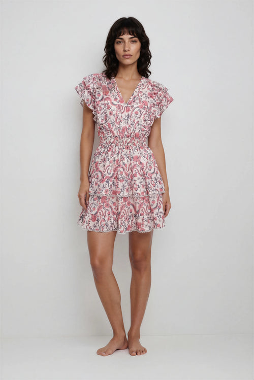 Woman wearing a pink floral dress on a white background