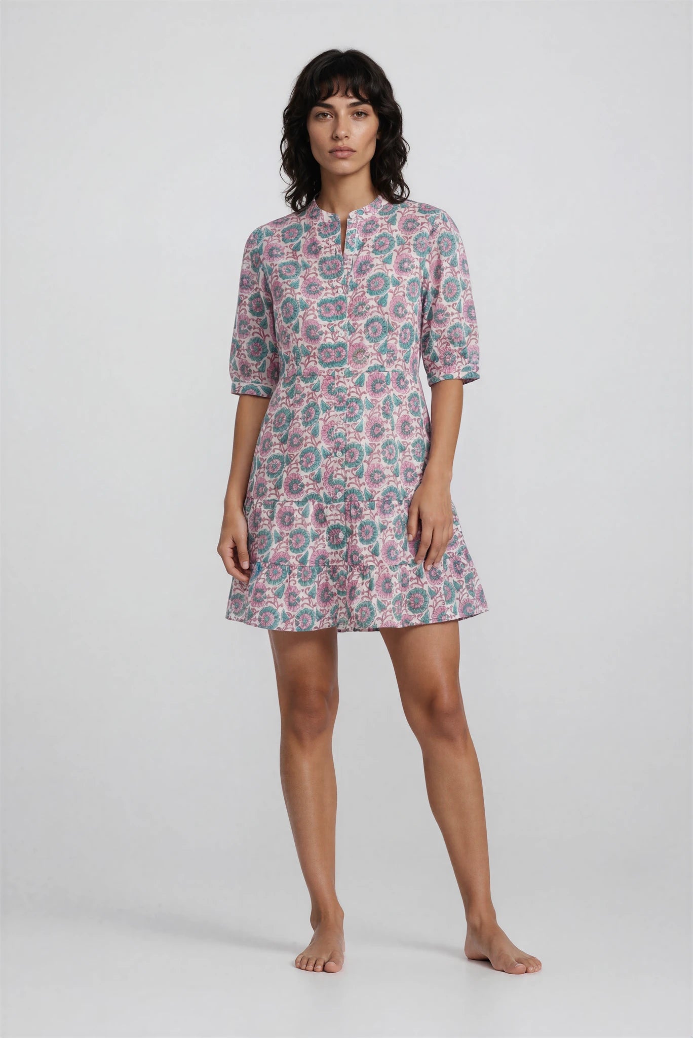 Woman wearing a patterned dress on a white background