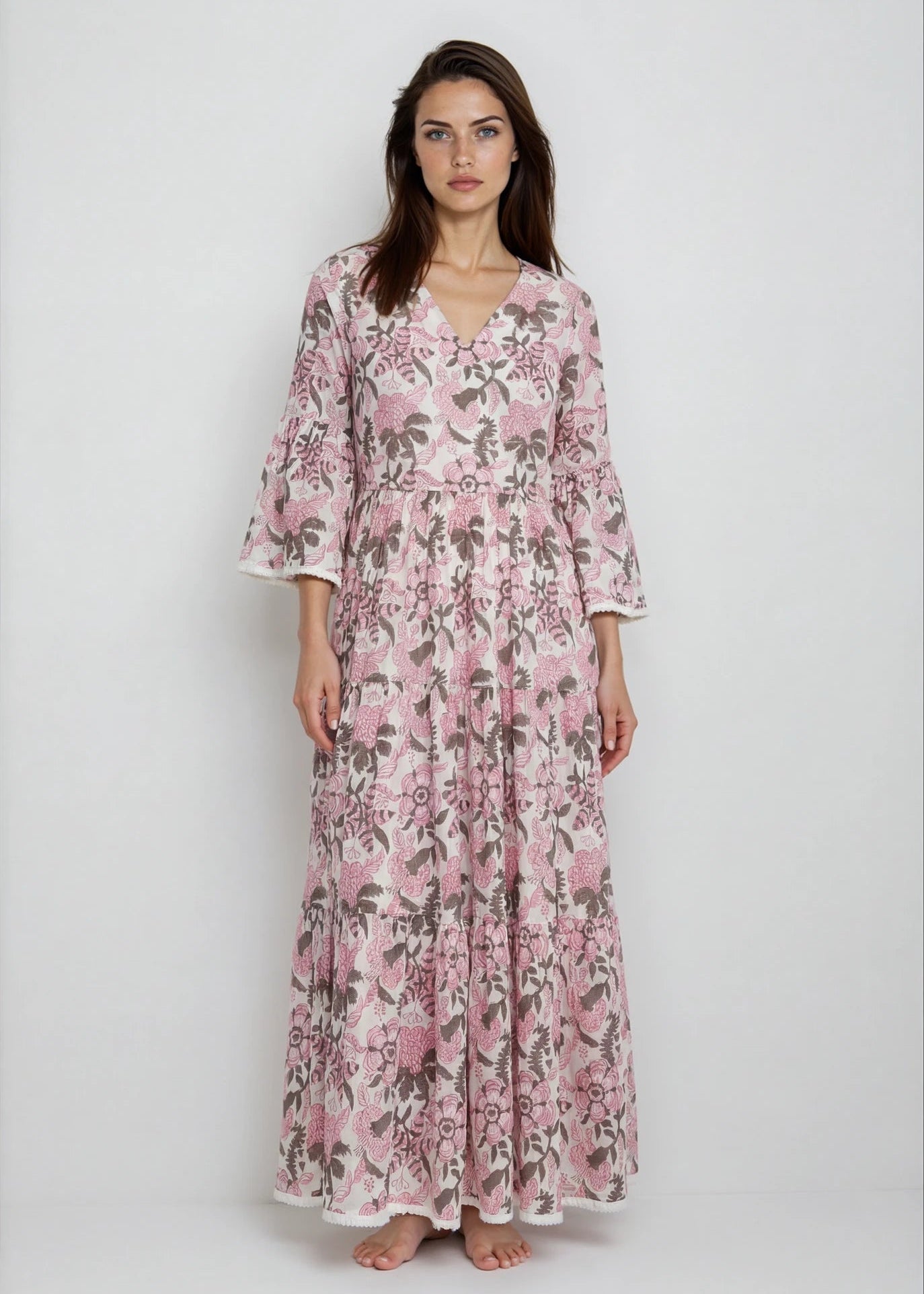 Woman wearing a pink floral dress on a white background
