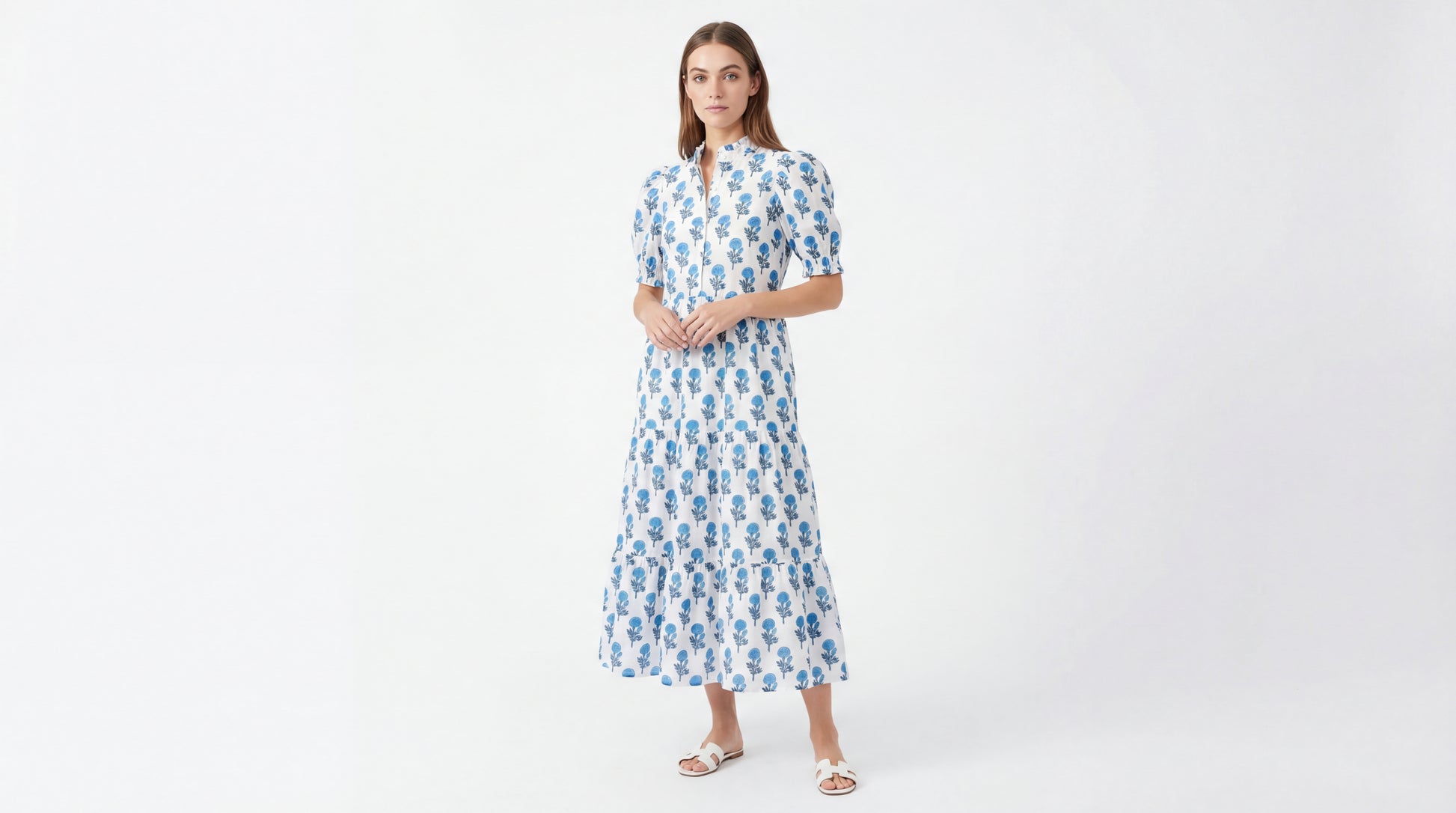 Woman wearing a blue floral dress on a white background