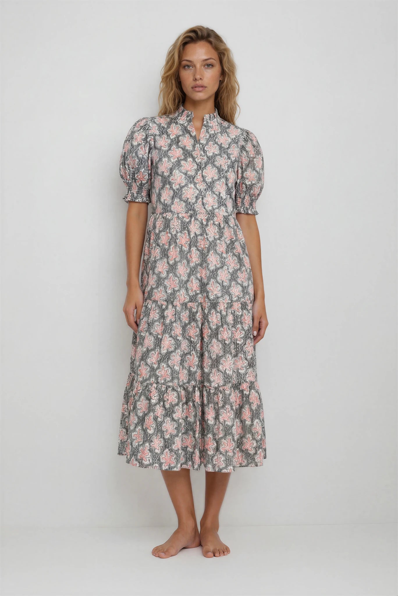 Woman wearing a floral dress on a plain background