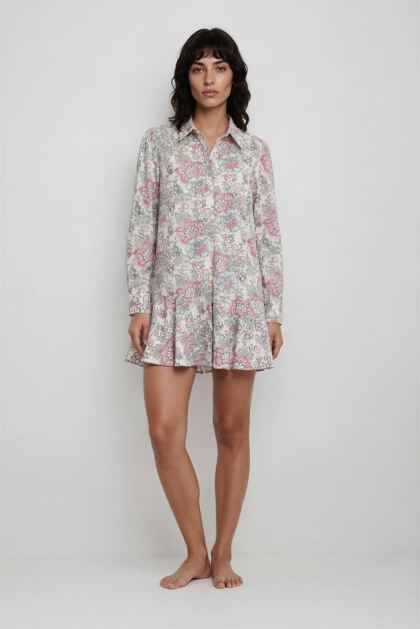 Woman wearing a floral patterned nightshirt on a white background
